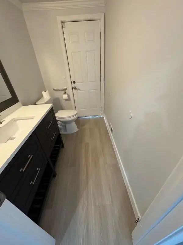 Bathroom with espresso vanity and wood-look flooring