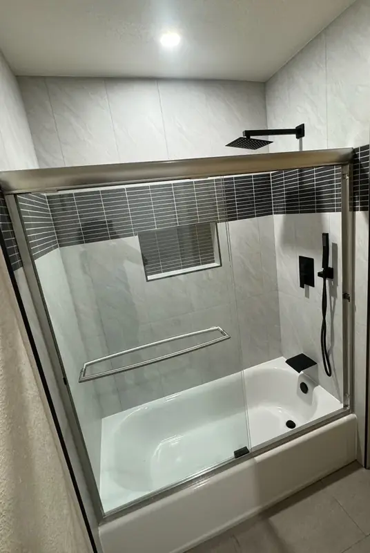 Alcove tub with glass slider and marble surround
