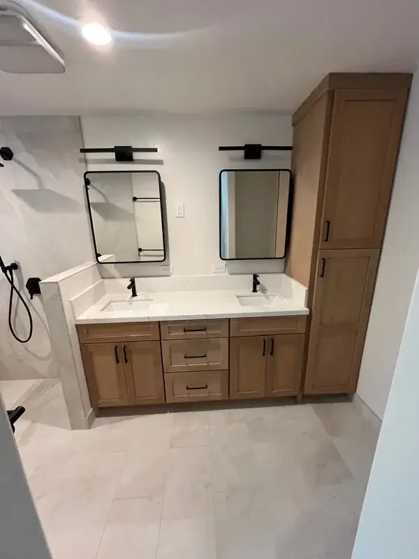 Master bathroom with wood double vanity and black-framed mirrors