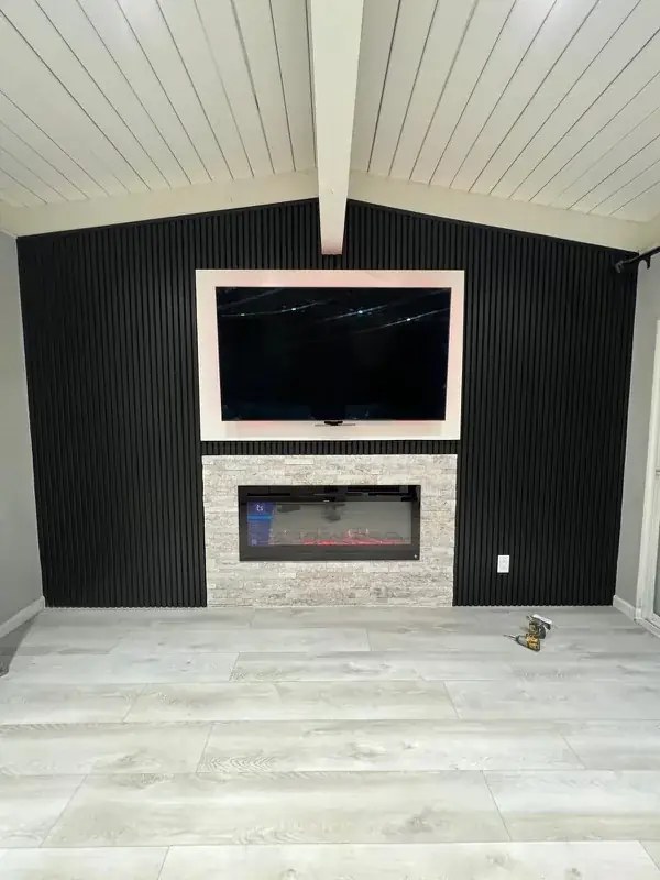 Black fluted feature wall with a linear fireplace