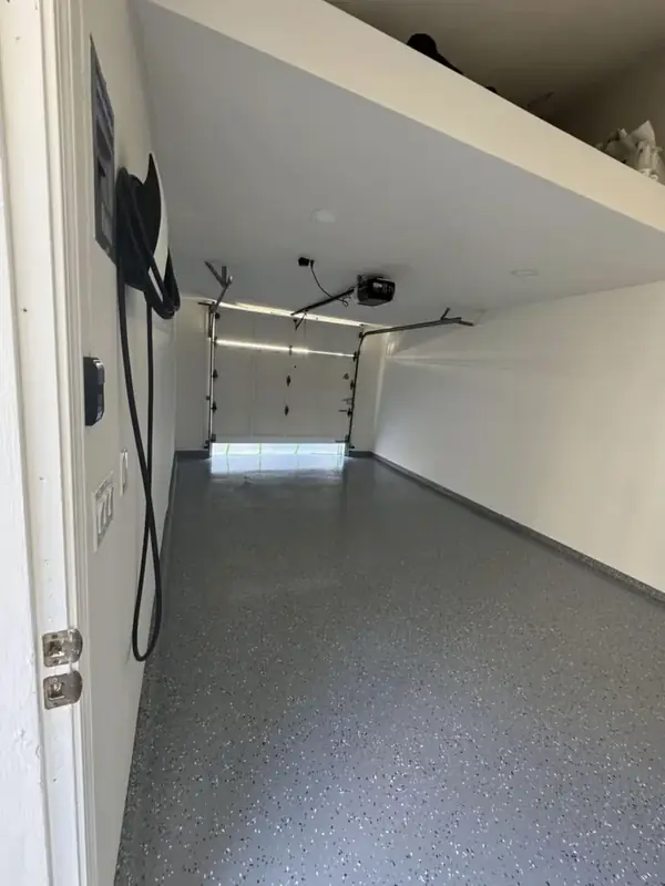 Garage with gray epoxy flake floor and overhead storage platform